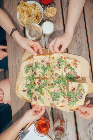 Unser Soleil-Flammkuchen mit getrockneten Tomaten, Kalamata-Oliven, Parmesan und Rucola.